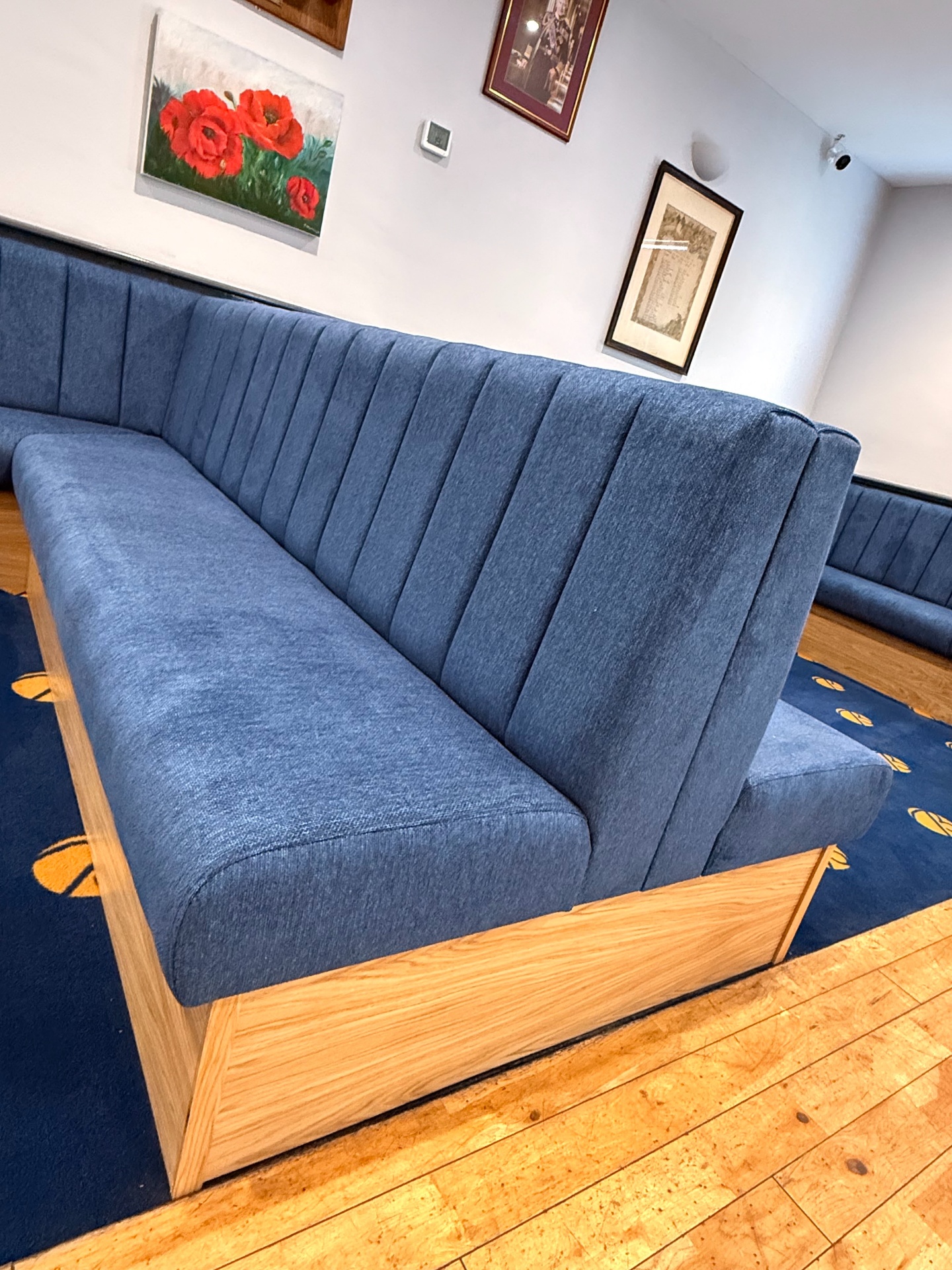 Close-up detail of a fluted channel-back banquette back in blue Crib 5 upholstery