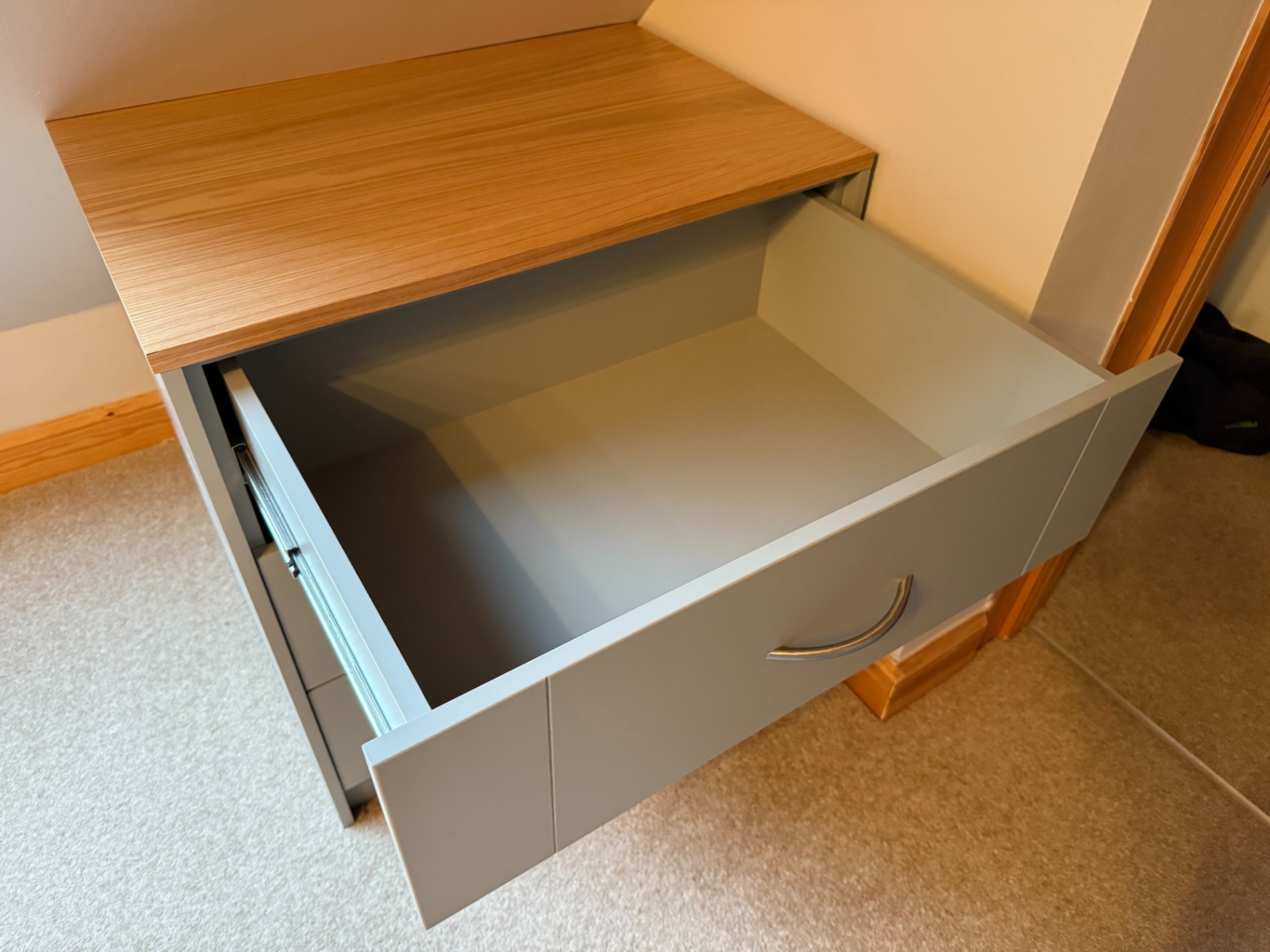 Open drawer of a bespoke fitted chest showing hardwood construction