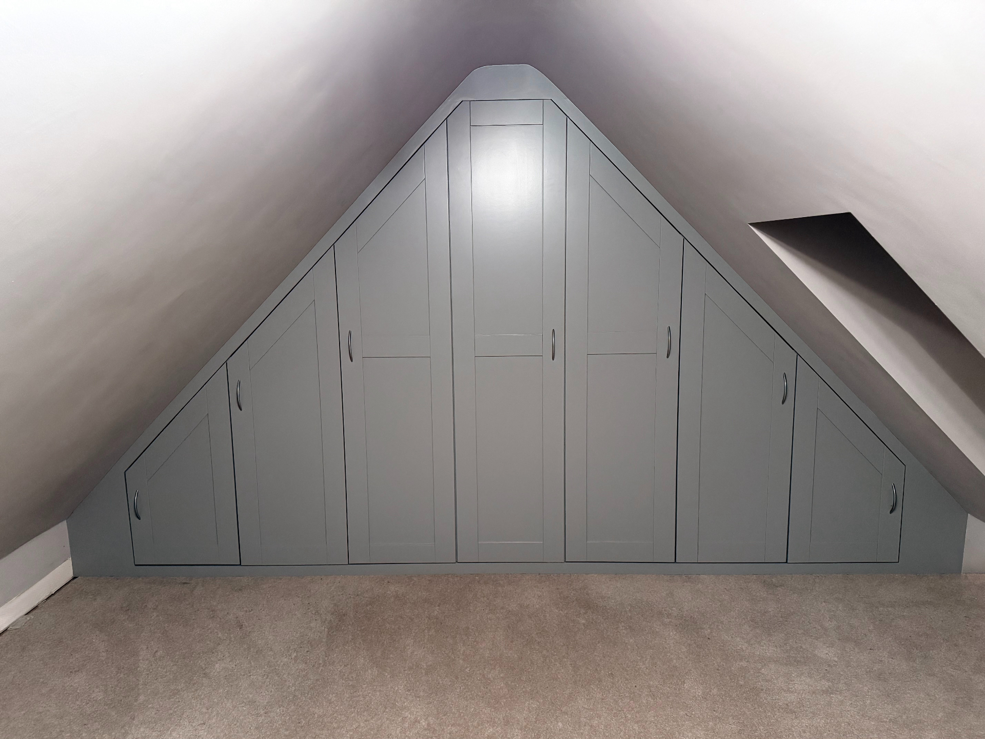 Bespoke eaves wardrobe with panelled doors closed